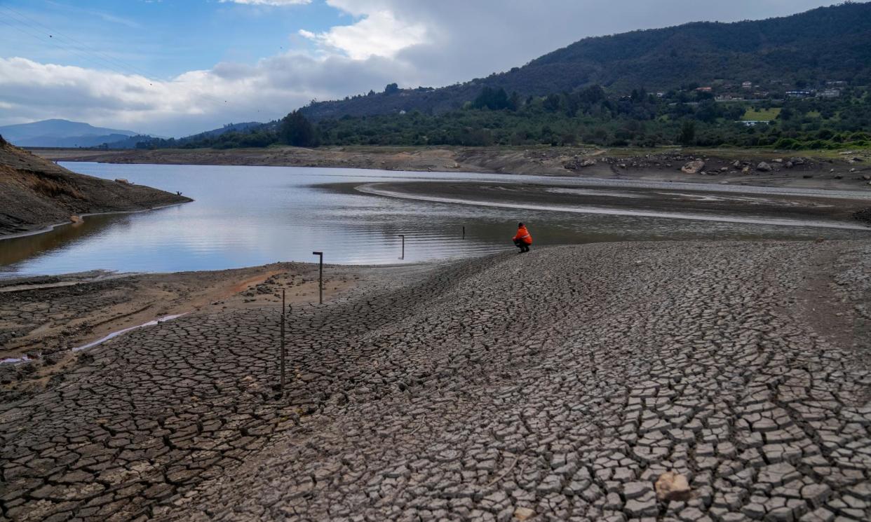 <span>A worker of Bogota's water company monitors the level of the San Rafael reservoir, a source of drinking water for Bogota that is low due to the El Niño weather phenomenon, in La Calera on the outskirts of Bogota, Colombia, Monday, April 8, 2024. </span><span>Photograph: Fernando Vergara/AP</span>