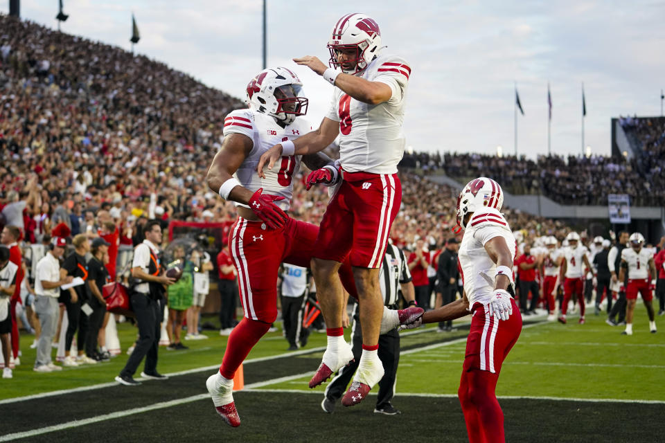 Wisconsin quarterback Tanner Mordecai (8) celebrates a touchdown with running back Braelon Allen (0) during the first half of an NCAA college football game against Purdue in West Lafayette, Ind., Friday, Sept. 22, 2023. (AP Photo/Michael Conroy)