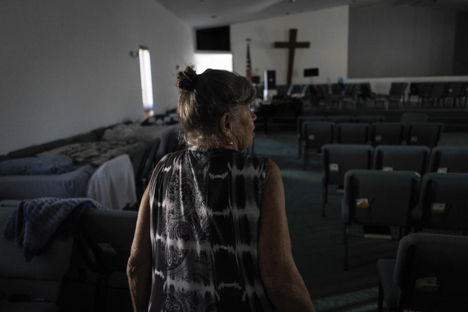 Barbara Wasko walks through the sanctuary of the Southwest Baptist Church in Fort Myers, Fla., Sunday, Oct. 2, 2022. She took refuge inside the church when Hurricane Ian swept through Southwest Florida. (AP Photo/Robert Bumsted)