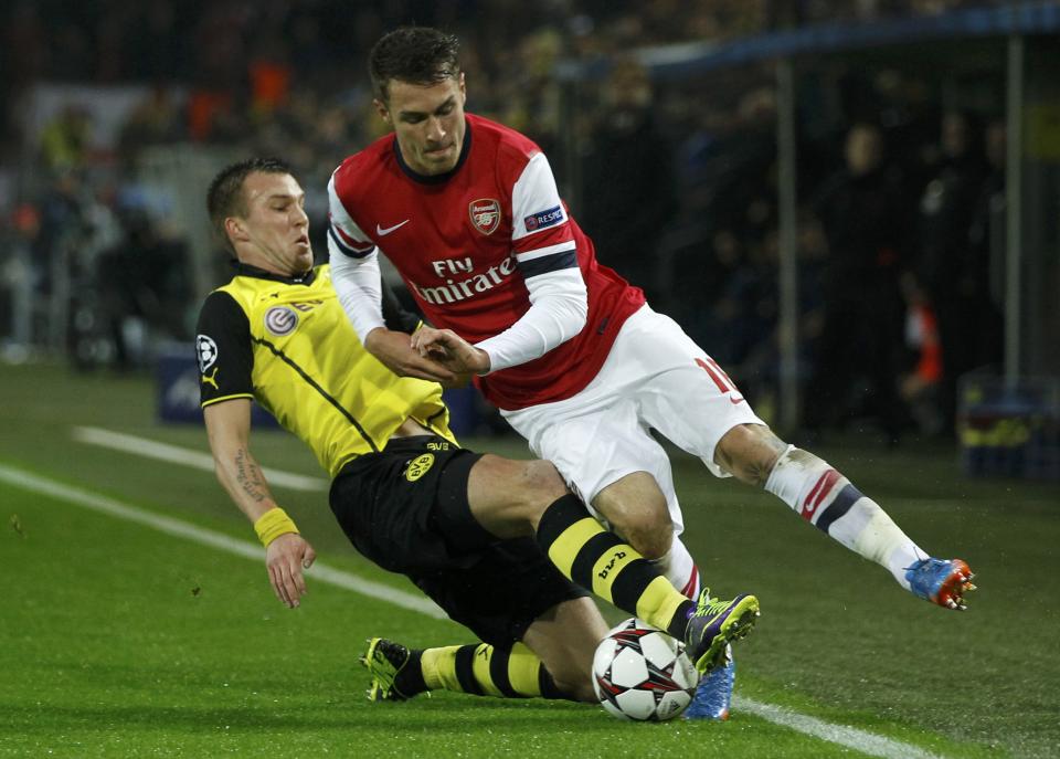 Borussia Dortmund's Kevin Grosskreutz tackles Arsenal's Aaron Ramsey (R) during their Champions League Group F soccer match in Dortmund November 6, 2013. REUTERS/Ina Fassbender (GERMANY - Tags: SPORT SOCCER)