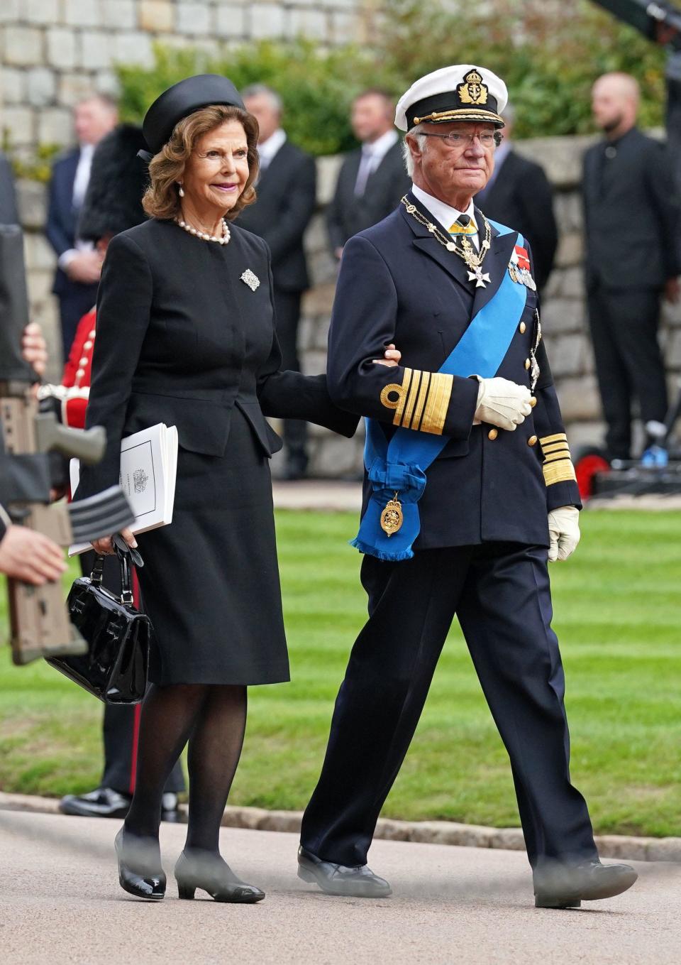 Queen Silvia of Sweden and Carl XVI Gustaf King of Sweden arrive at the Committal Service for Queen Elizabeth II held at St George's Chapel in Windsor Castle on September 19, 2022.