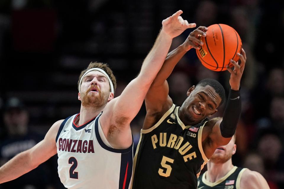 Gonzaga forward Drew Timme (2) and Purdue guard Brandon Newman (5) reach for a rebound during the first half of an NCAA college basketball game in the Phil Knight Legacy tournament Friday, Nov. 25, 2022, in Portland, Ore. (AP Photo/Rick Bowmer)