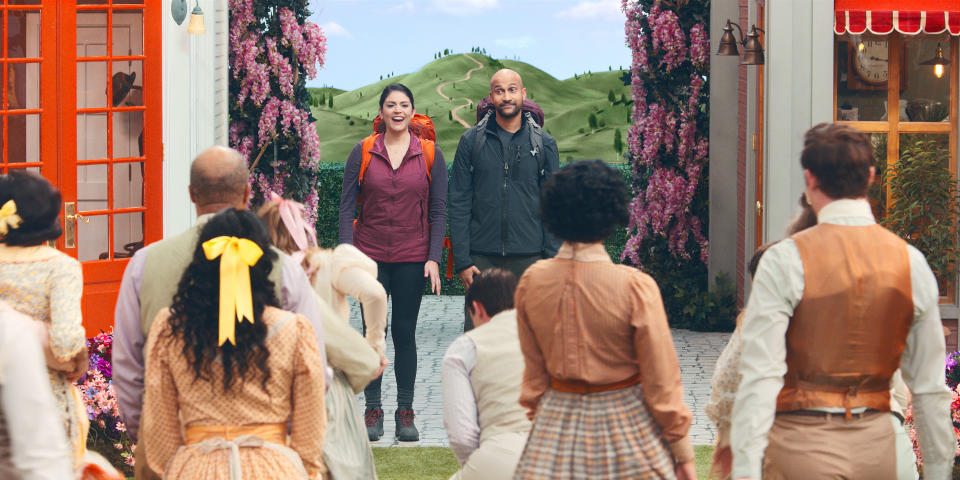 This image released by Apple TV+ shows Cecily Stron, background left, and Keegan-Michael Key in a scene from "Schmigadoon!,” premiering Friday. (Apple TV+ via AP)