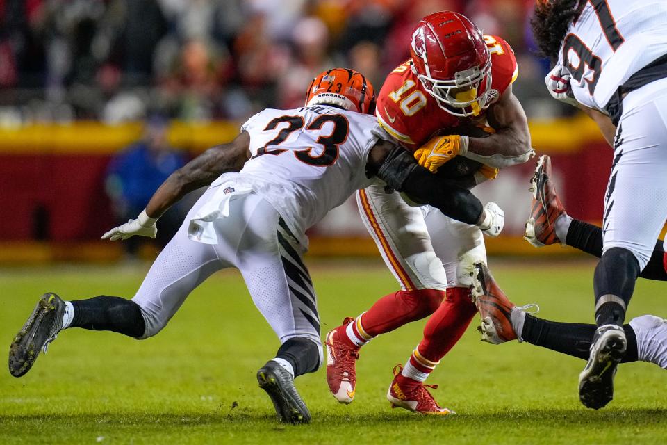 Kansas City Chiefs running back Isiah Pacheco (10) leans into a tackle from Cincinnati Bengals safety Dax Hill (23) in the fourth quarter of the NFL Week 17 game between the Kansas City Chiefs and the Cincinnati Bengals at Arrowhead Stadium in Kansas City, Mo., on Sunday, Dec. 31, 2023. The Chiefs won 25-17 to clinch the AFC West Championship.