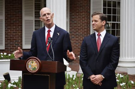 Florida Governor Rick Scott (L) formally introduces Lieutenant Governor Carlos Lopez-Cantera prior to a luncheon at the Governor's Mansion in Tallahassee, Florida in this file photo from January 3, 2014. REUTERS/Bill Cotterell/Files