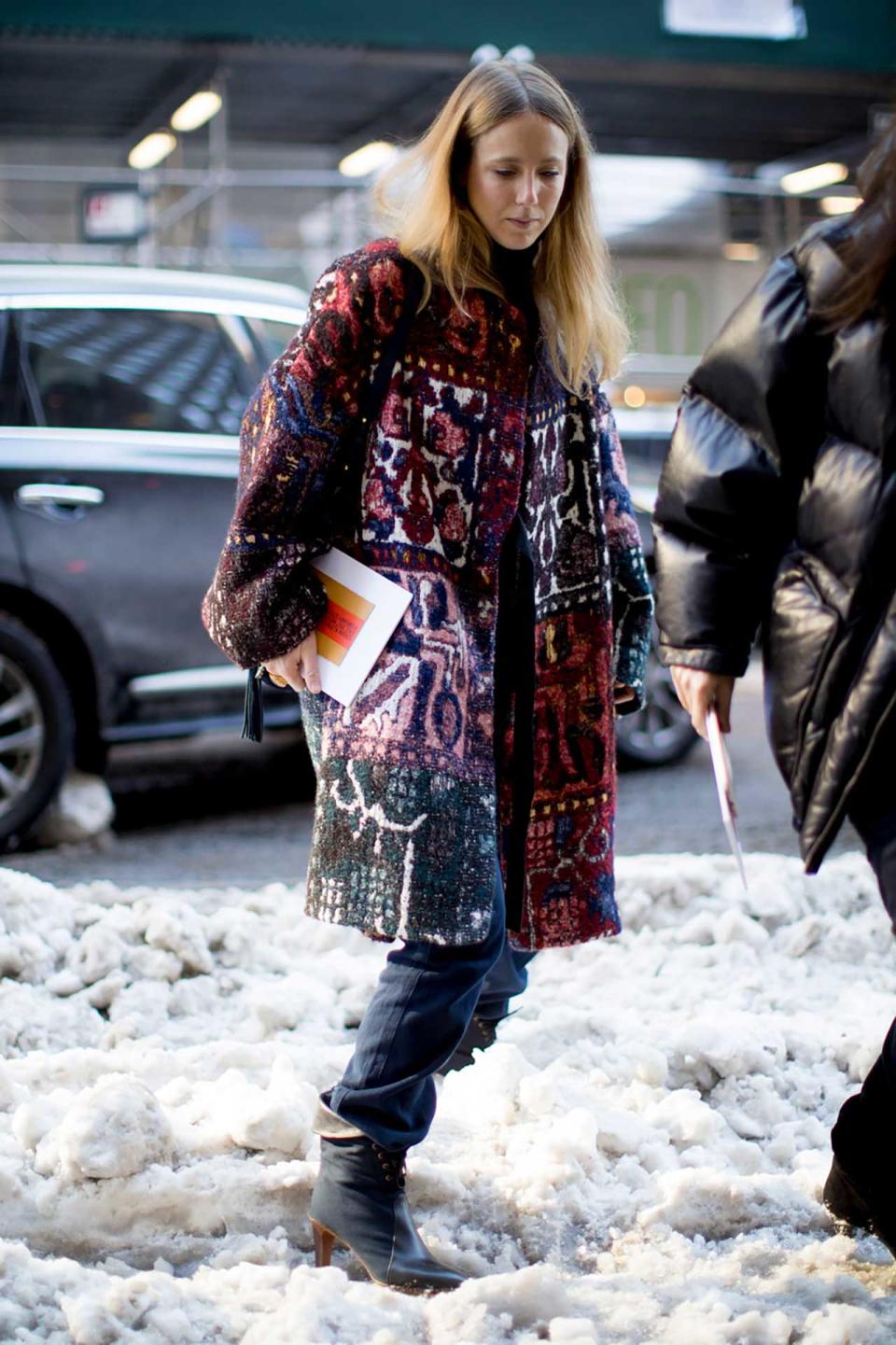 In A Tapestry Coat And Chloé Boots