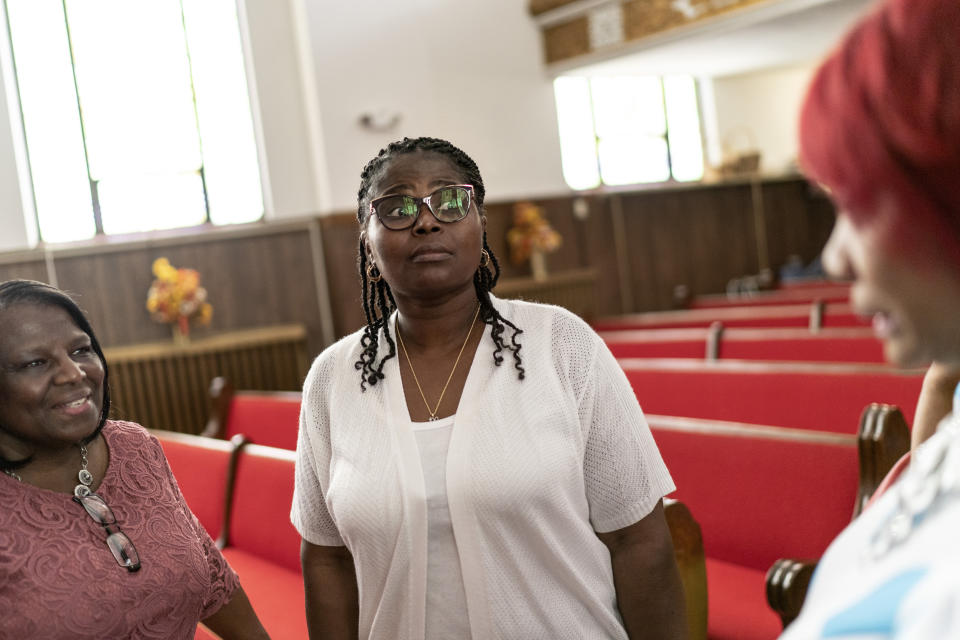 Tameka Felts, center, a church trustee who also is licensed to carry a gun, talks with congregants following a service at Trinity Baptist Church Sunday, Aug. 20, 2023, in Niagara Falls, N.Y. She does not bring her gun into church but is reassured knowing the pastor is armed. "You always have to wonder, 'Who is that person coming into the building?" she says. "Coming in to church you should not have to feel like that, but you do." (AP Photo/David Goldman)