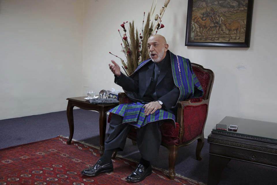 Former Afghan President Hamid Karzai gestures while speaking during an interview with The Associated Press, in Kabul, Afghanistan, Tuesday, Dec. 10, 2019. Karzai, whose final years in power were characterized by a cantankerous relationship with the United States, said on Tuesday that Washington used blackmail and corruption to manipulate his officials, undermine his government and foment violence among the country's many factions. (AP Photo/Altaf Qadri)