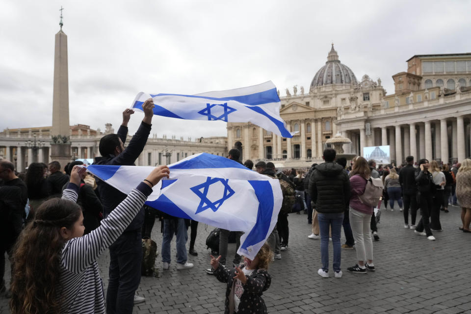 FILE - People hold Israeli flags at the end of Pope Francis' Angelus noon prayer in St. Peter's Square at the Vatican on Nov. 12, 2023. (AP Photo/Gregorio Borgia, File)