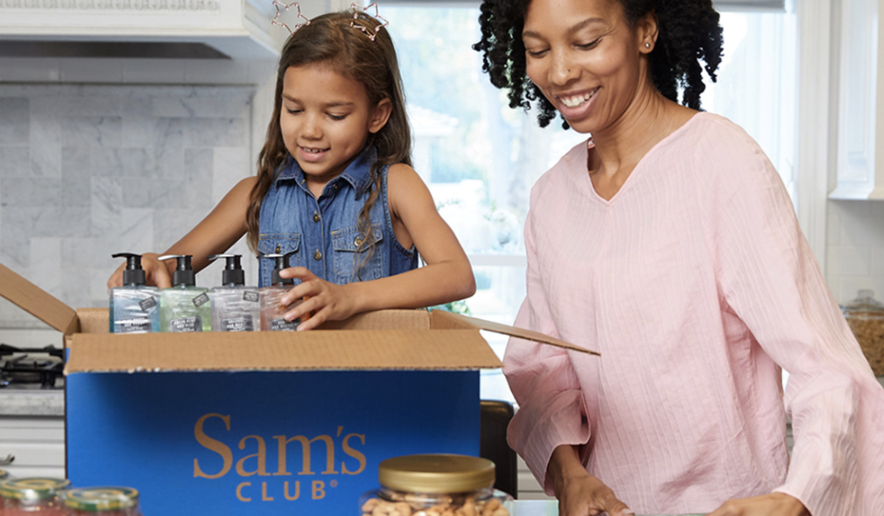 Mother and daughter unboxing groceries in the kitchen.