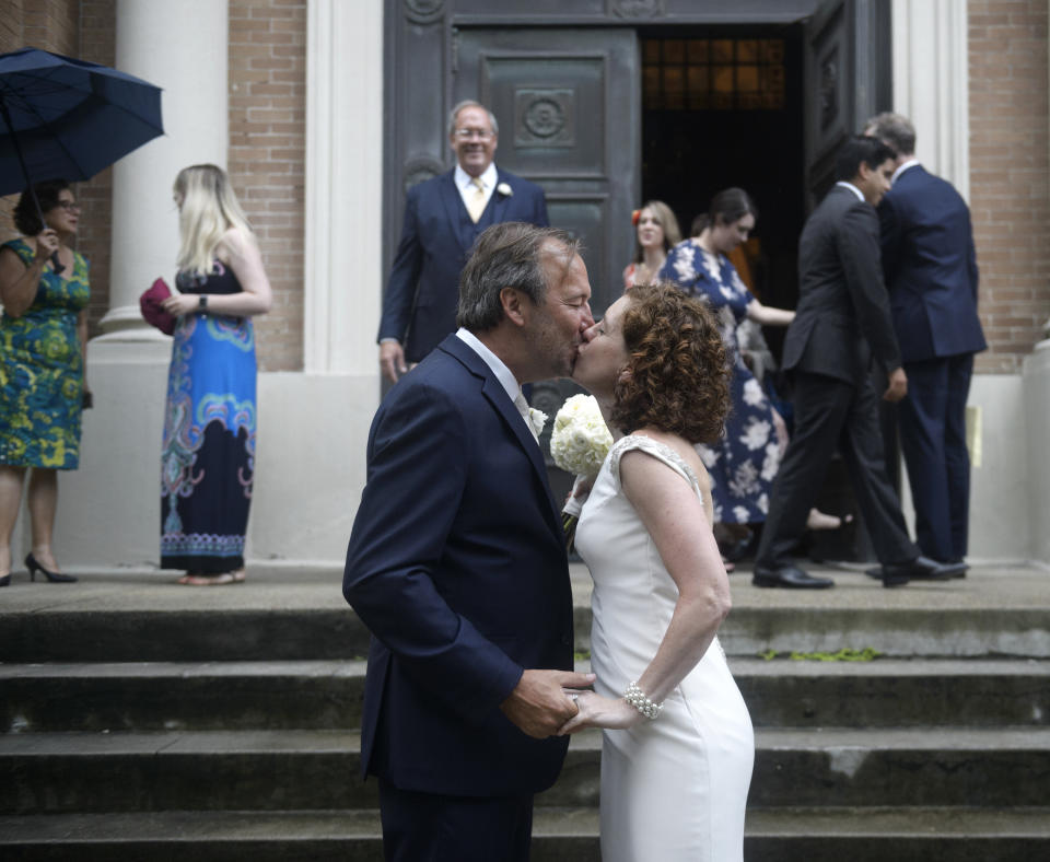 Associated Press staff photographer Gerald Herbert and Lucy Sikes kiss after being wed at Mater Dolorosa Catholic Church ahead of Tropical Storm Barry in New Orleans, Friday, July 12, 2019. Originally scheduled for Saturday, the couple moved the nuptials up a day to avoid the arrival of Barry. (Max Becherer/The Advocate via AP)