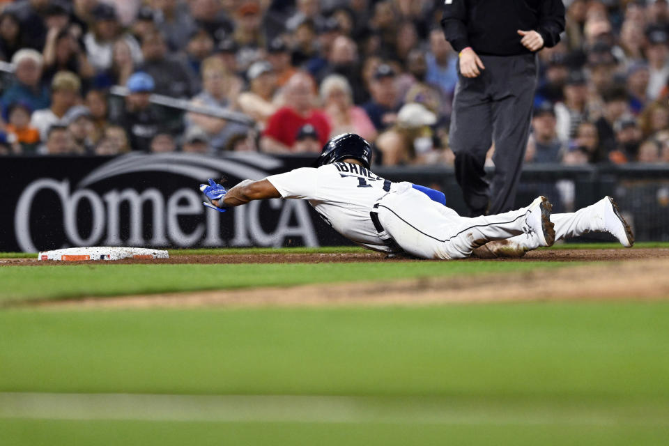 Detroit Tigers' Andy Ibanez dives toward third base, advancing from first after a wild pitch and a throwing error during the sixth inning of a baseball game Tuesday, Aug. 22, 2023, in Detroit. (AP Photo/Jose Juarez)