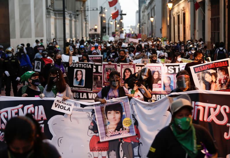 Demonstrators march during a protest to mark the International Day for the Elimination of Violence against Women, in Lima