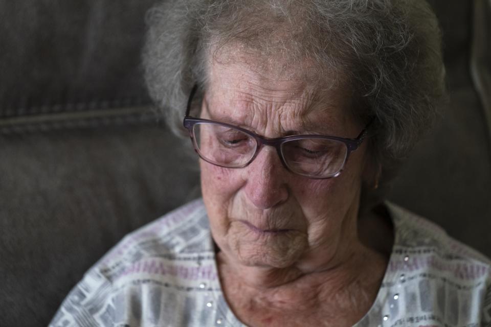 Norma Carr, who was displaced by the train derailment in East Palestine pauses during an interview with The Associated Press at the home she is temporary staying at in Columbiana, Ohio, Wednesday, April 5, 2023. Carr raised four children in the cedar-sided 1930s duplex she moved into 57 years ago and where three generations lived together before the derailment. (AP Photo/Matt Rourke)