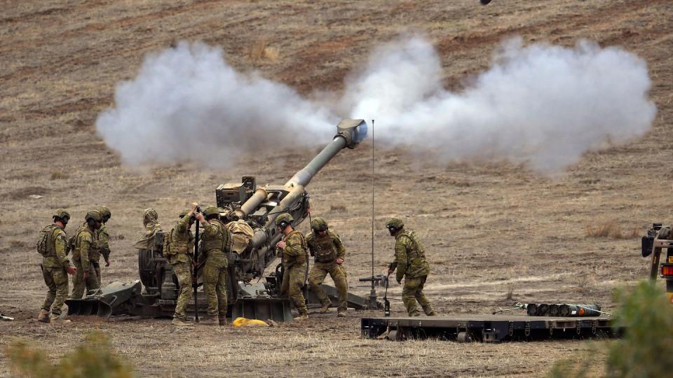 Australian soldiers fire a round from a 155mm howitzer during a live-fire demonstration showcasing the service's joint combined-arms capabilities in 2019. (William West/AFP via Getty Images)