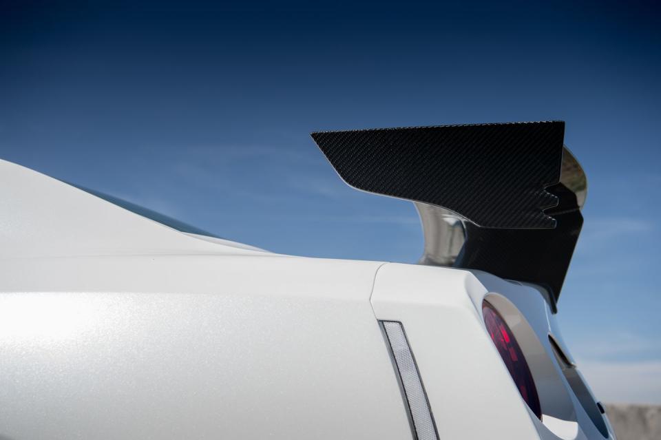 <p>An unpainted carbon-fiber rear wing keeps the tail planted at the claimed top speed of 186 mph.</p>