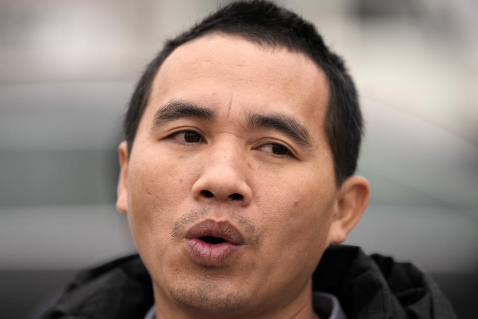 Vietnamese worker Nguyen Van Tri speaks to the media in front of a barrack near the northern Serbian town of Zrenjanin, 50 kilometers north of Belgrade, Serbia, Thursday, Nov. 18, 2021. Reports have emerged in Serbia of prison-like conditions for some 500 of them at the construction site in north of the country where China's Shandong Linglong Tire Co is building the huge factory. Populist-run Serbia is a key spot for China's expansion and investment policies in Europe and Chinese companies have kept a tight lid on their projects in the country amid reports of disrespect of the Balkan nation's anti-pollution laws and labor regulations. (AP Photo/Darko Vojinovic)