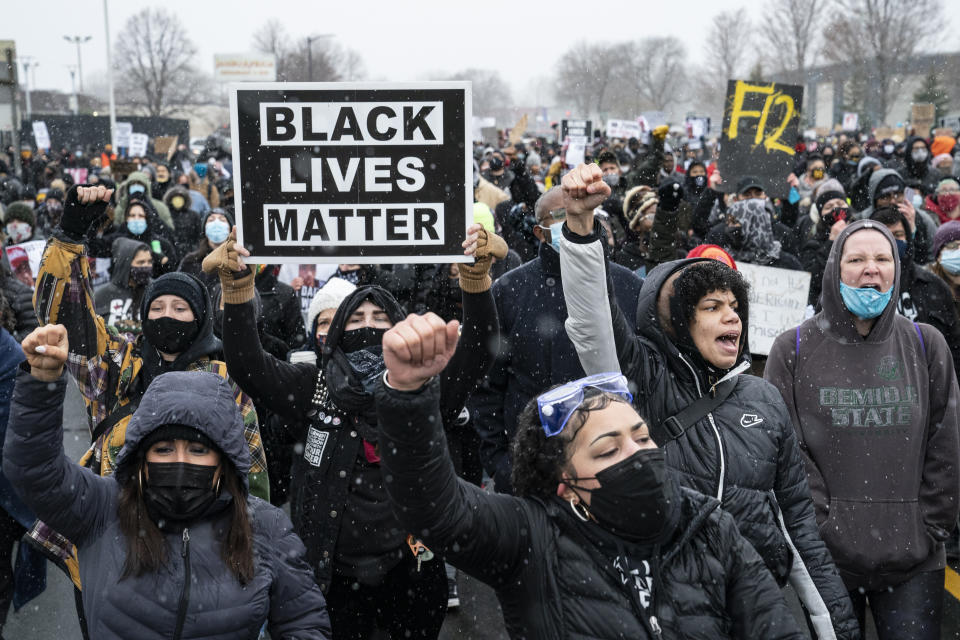 Demonstrators march to Brooklyn Center Police Department to protest the fatal shooting of Daunte Wright during a traffic stop, Tuesday, April 13, 2021, in Brooklyn Center, Minn. (AP Photo/John Minchillo)