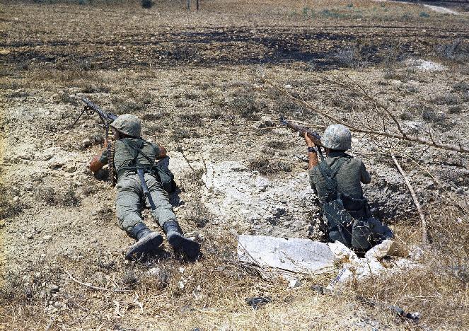 FILE - In this file photo dated July 25, 1974, Turkish troops in position on the frontline some 500 yards form the outer perimeter and 400 yards from Greek position at the Nicosia Airport, Cyprus. Europe's top human rights court on Monday May 12, 2014, ordered Turkey to pay 90 million euros ($123 million) to Cyprus over the 1974 invasion of the island and its subsequent division, in one of the largest judgments in its history, saying that the passage of time did not erase responsibility in the case. The judgment comes as the Turkish and Greek Cypriot communities are engaged in renewed efforts to reunite the island. (AP Photo/Max Nash, FILE)