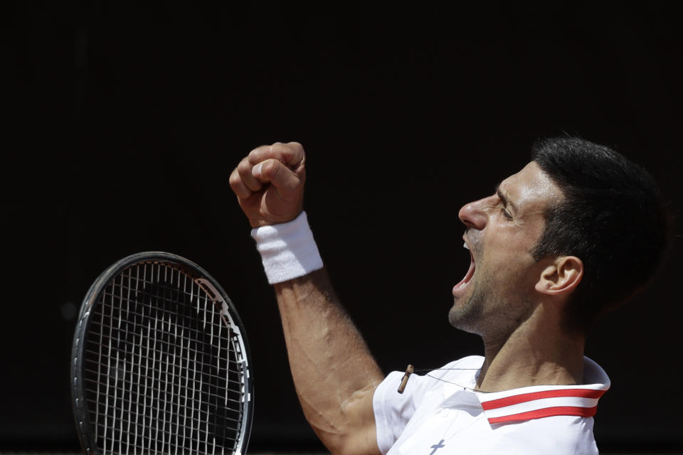 Serbia's Novak Djokovic celebrates after winning a point to Greece's Stefanos Tsitsipas during their quarter-final match at the Italian Open tennis tournament, in Rome, Saturday, May 15, 2021. (AP Photo/Gregorio Borgia)