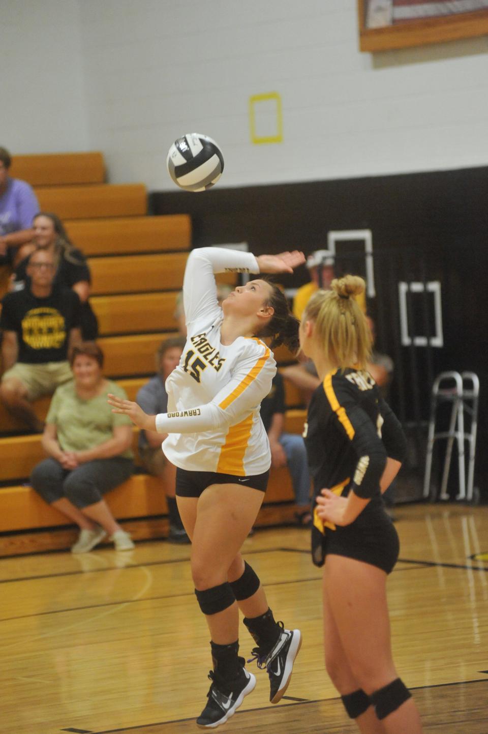 Colonel Crawford's Molli Teglovic serves against Wynford.