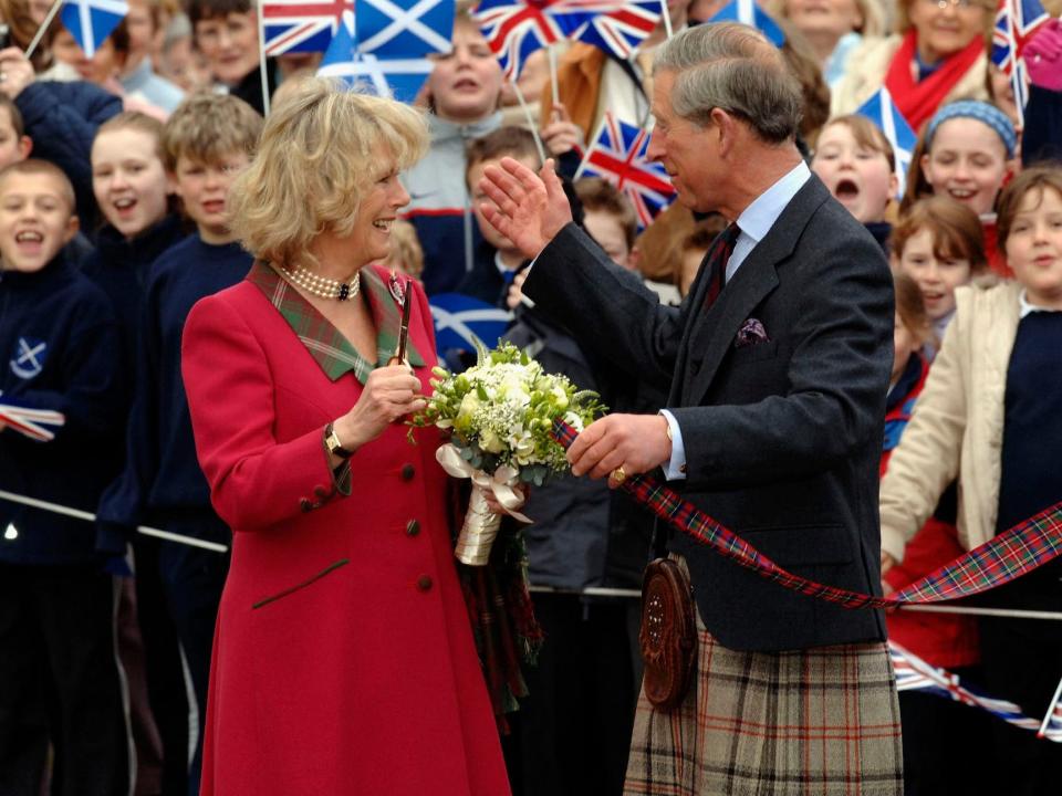 Camilla, Queen Consort and King Charles III in front of a crowd.