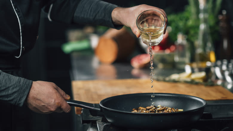 Pouring wine into pan
