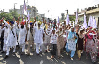 Farmers shout anti-government slogans as they march during a protest in Amritsar, India. Hundreds of Indian farmers took to the streets on Friday protesting new laws that the government says will boost growth in the farming sector through private investments, but they fear these are likely to be exploited by private players for buying their crops cheaply. (AP Photo/Prabhjot Gill)