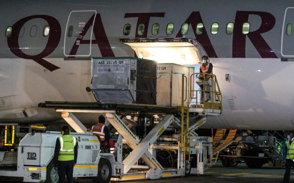 Boxes of vaccines donated by wealthier countries as part of the Covax scheme being offloaded in Kenya - AP Photo