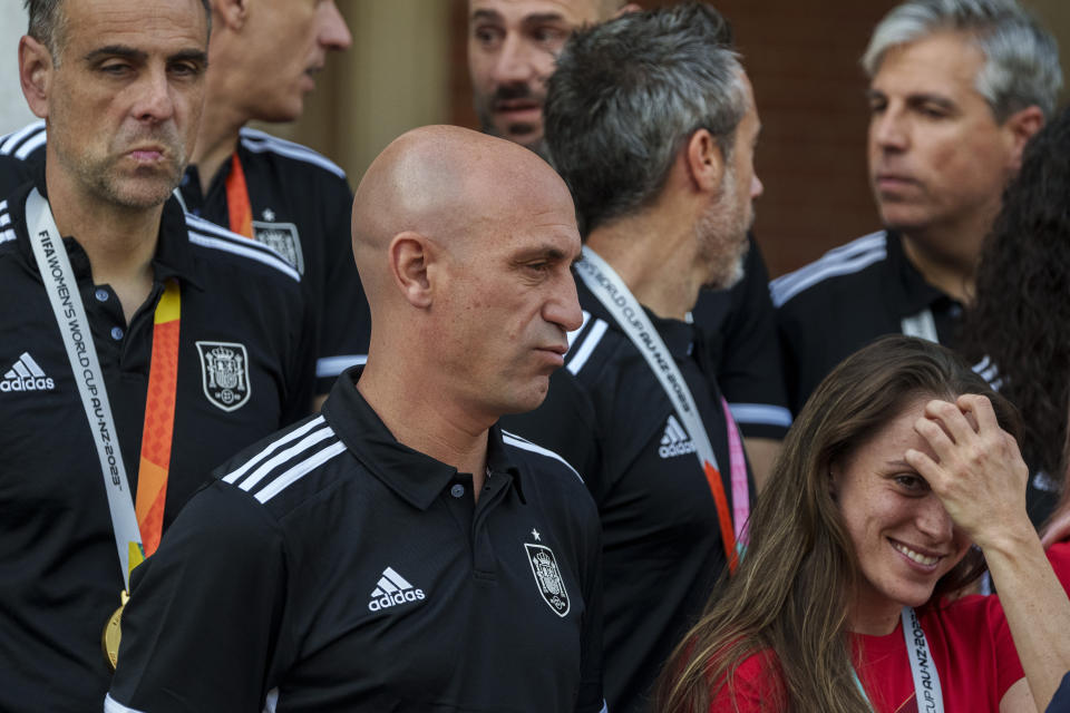 President of Spain's soccer federation, Luis Rubiales, center, stands with Spain's Women's World Cup soccer team after their World Cup victory at La Moncloa Palace in Madrid, Spain, Tuesday, Aug. 22, 2023. Moments after Spain won the Women's World Cup, the man who leads the country's national soccer federation took some unwanted attention away from the celebrating players. Criticism from the Spanish government and the soccer world rained down Monday on Luis Rubiales for his inappropriate conduct while reveling in Spain's 1-0 win over England in Sunday's final in Sydney, Australia. (AP Photo/Manu Fernandez)