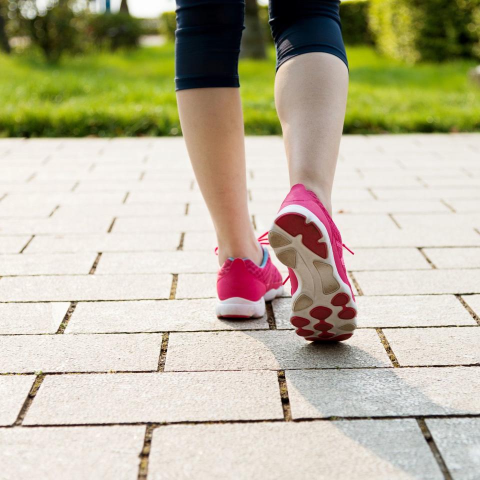 low section of woman walking in park