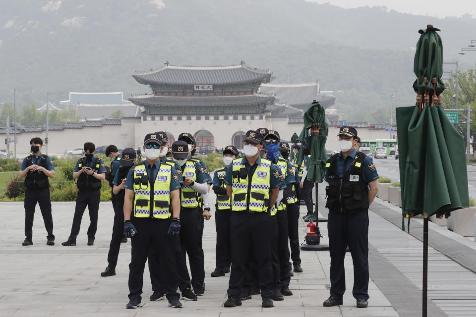 Police officers wearing face masks to help protect against the spread of the new coronavirus stand guard near the U.S. embassy in Seoul, South Korea, Friday, June 5, 2020. (AP Photo/Ahn Young-joon)