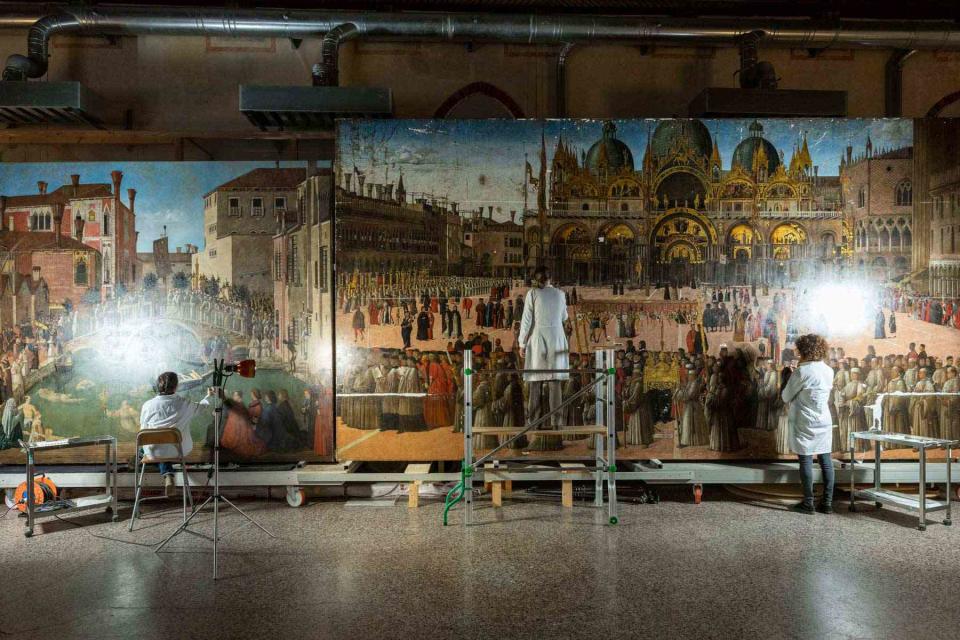 <p>Matteo De Fina/Courtesy of Save Venice</p> Ongoing conservation of Gentile Bellini’s Miracle of the Relic of the True Cross at the Bridge of San Lorenzo, 1500 (left) and Procession in Piazza San Marco, 1496, (right). 
