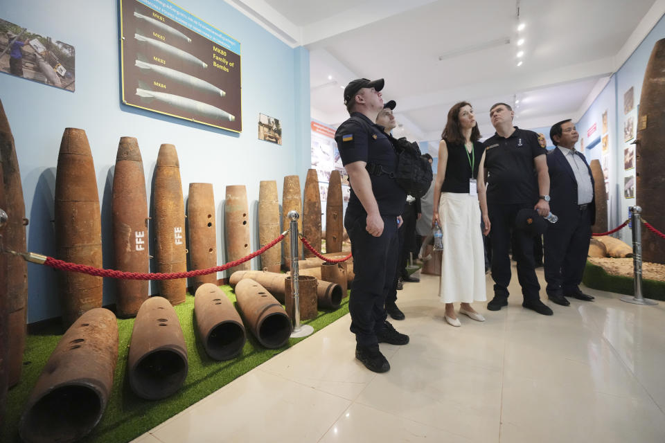 Ukrainian deminers view bomb casings recovered from the war during a tour of the Peace Museum Mine Action in Siem Reap province of northwestern Cambodia, Friday, Jan. 20, 2023. Cambodian experts, whose country has the dubious distinction of being one of the world's most contaminated by landmines, walked a group of Ukrainian soldiers through a minefield being actively cleared hoping their decades of experience will help the Europeans in their own efforts to remove Russian mines at home. (AP Photo/Heng Sinith)
