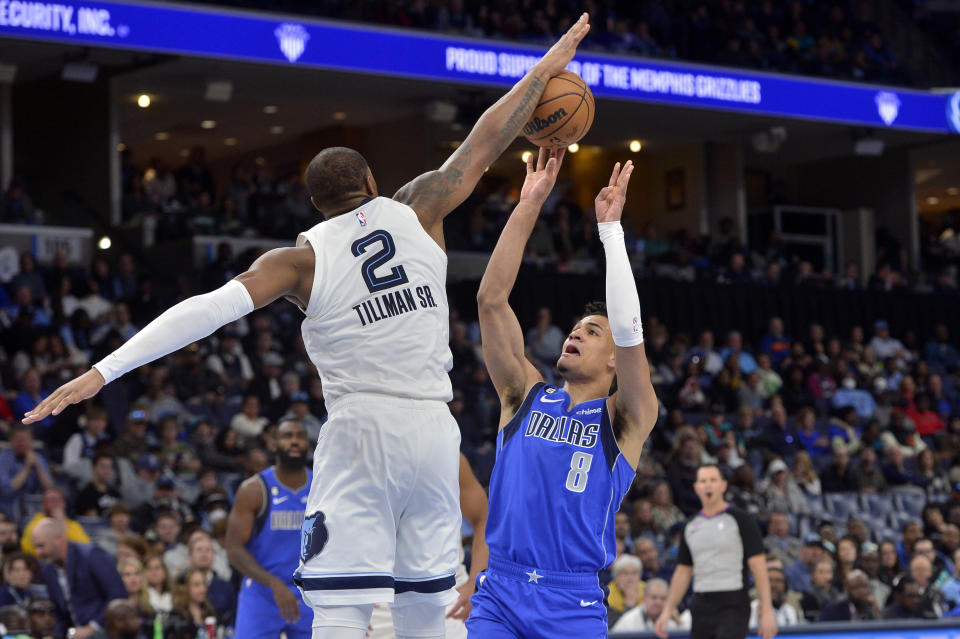 Memphis Grizzlies forward Xavier Tillman (2) blocks a shot by Dallas Mavericks guard Josh Green (8) in the first half of an NBA basketball game Monday, March 20, 2023, in Memphis, Tenn. (AP Photo/Brandon Dill)