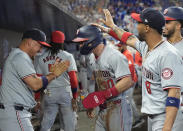 Washington Nationals' Jacob Young (30) is congratulated by his teammates after scoring during the third inning of a baseball game against the Miami Marlins, Saturday, April 27, 2024, in Miami. (AP Photo/Marta Lavandier)