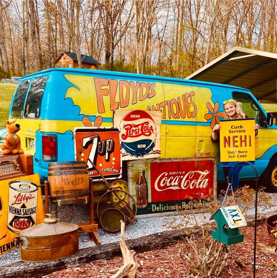 Angela Taylor, owner of Floyd's Antiques & Estate Sales, has her van parked in front of The Front Porch, where Floyd's has several items for sale.