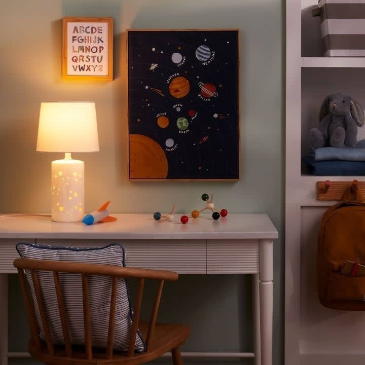 a lamp with star cutouts on a desk