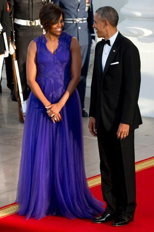 Michelle Obama with her husband, President Barack Obama, in an electri cpurple Tadashi Shoji gown. 