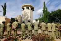 Prison officials stand guard to recieve Nigeria's President Muhammadu Buhari at the Kuje prison, in Abuja