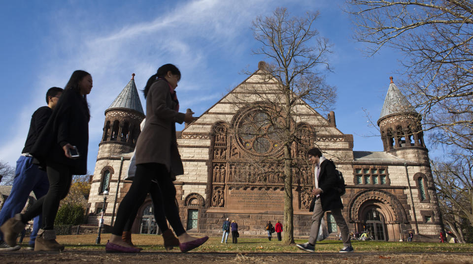 People walk around the Princeton University campus in New Jersey, November 16, 2013. A meningitis vaccine approved for use in Europe and Australia but not in the United States can be imported to try to stop an outbreak of the disease at Princeton University in New Jersey, federal health officials said. The Food and Drug Administration agreed this week to the importation of the vaccine, Bexsero, for potential use on the Ivy League campus, Barbara Reynolds, a spokeswoman for the Centers for Disease Control and Prevention, said on Saturday. REUTERS/Eduardo Munoz (UNITED STATES - Tags: SOCIETY EDUCATION HEALTH)