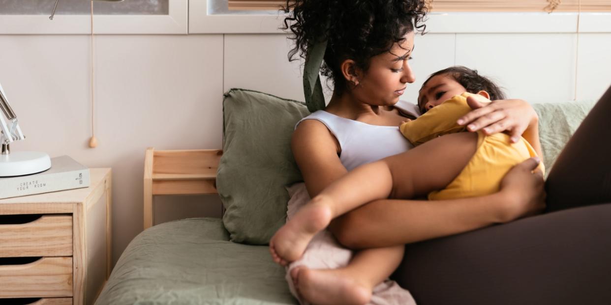 Indian Mother Hugging Toddler On Bed mantra for mamas