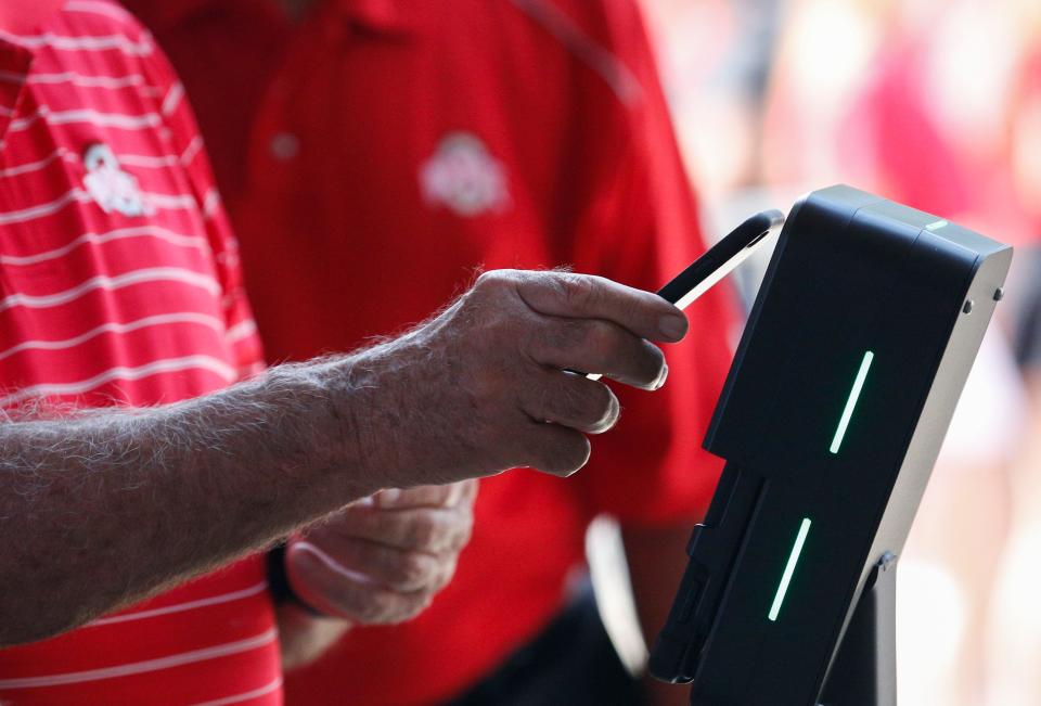 An Ohio State Buckeyes fan uses their mobile device at a ticket kiosk to enter Ohio Stadium before a NCAA Division I football game between the Ohio State Buckeyes and the Tulsa Golden Hurricane on Saturday, Sept. 18, 2021 in Columbus, Ohio.