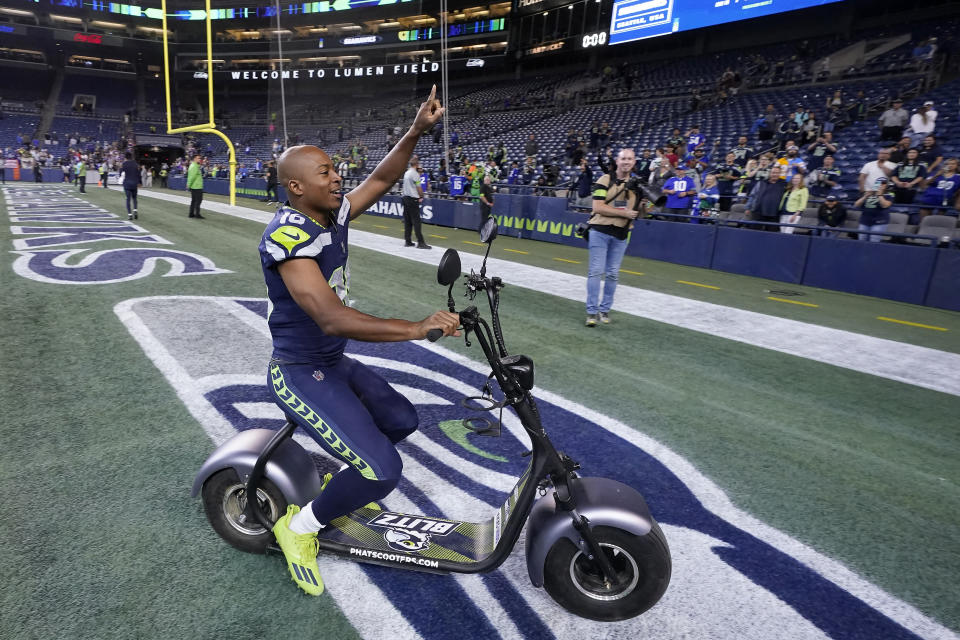 Seattle Seahawks wide receiver Tyler Lockett gestures toward fans after an NFL preseason football game against the Minnesota Vikings in Seattle, Thursday, Aug. 10, 2023. (AP Photo/Gregory Bull)