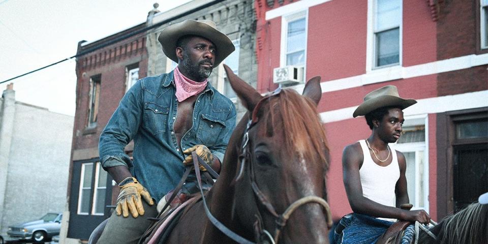 Harp (Idris Elba, left) teaches his estranged son Cole (Caleb McLaughlin) how to ride a horse in "Concrete Cowboy."