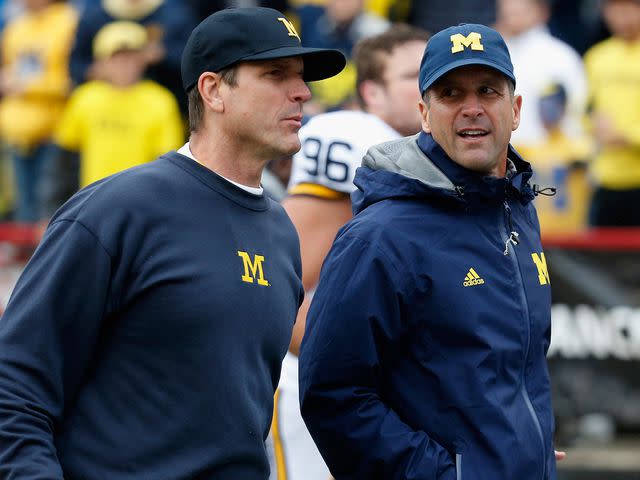 <p>Rob Carr/Getty</p> Jim Harbaugh and Jim Harbaugh following halftime of the Michigan and Maryland Terrapins game at Byrd Stadium on October 3, 2015 in College Park, Maryland.