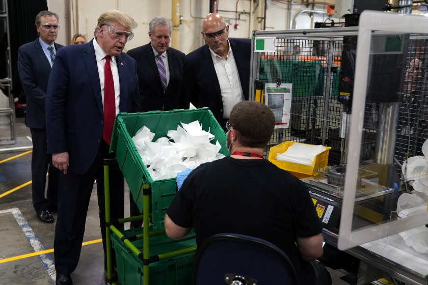 President Donald Trump participates in a tour of a Honeywell International plant that manufactures personal protective equipment, Tuesday, May 5, 2020, in Phoenix. (AP Photo/Evan Vucci)