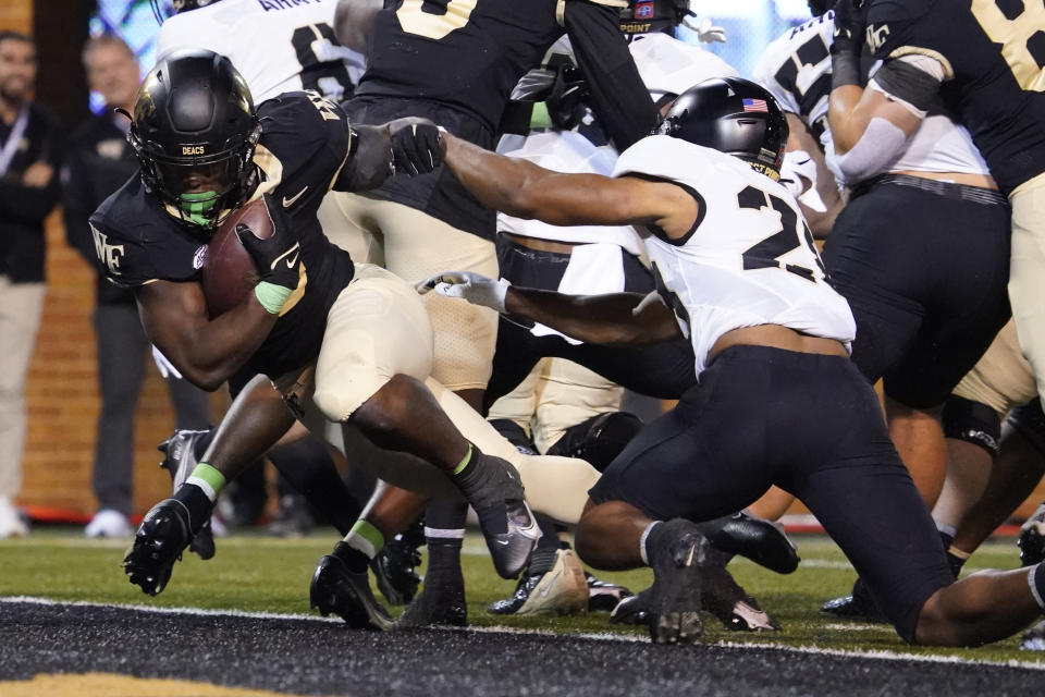 Wake Forest running back Justice Ellison, left, runs into the end zone for a touchdown against Army during the first half of an NCAA college football game in Winston-Salem, N.C., Saturday, Oct. 8, 2022. (AP Photo/Chuck Burton)