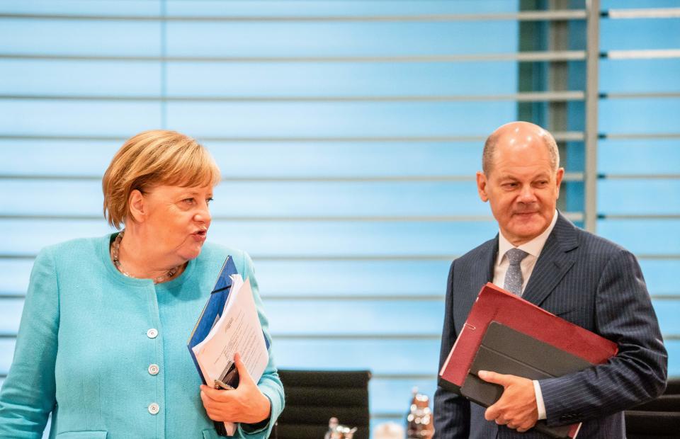 German Chancellor Angela Merkel and German Finance Minister and Vice-Chancellor Olaf Scholz arrive for the weekly cabinet meeting on August 19, 2020 at the Chancellery in Berlin. (Photo by Michael Kappeler / POOL / AFP) (Photo by MICHAEL KAPPELER/POOL/AFP via Getty Images)