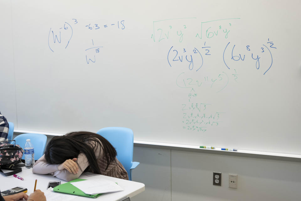 A student takes a break next to a whiteboard during a summer math boot camp on Thursday, Aug. 1, 2023 at George Mason University in Fairfax. Va. The pandemic disrupted all learning but caused an outsize impact in math. (AP Photo/Kevin Wolf)